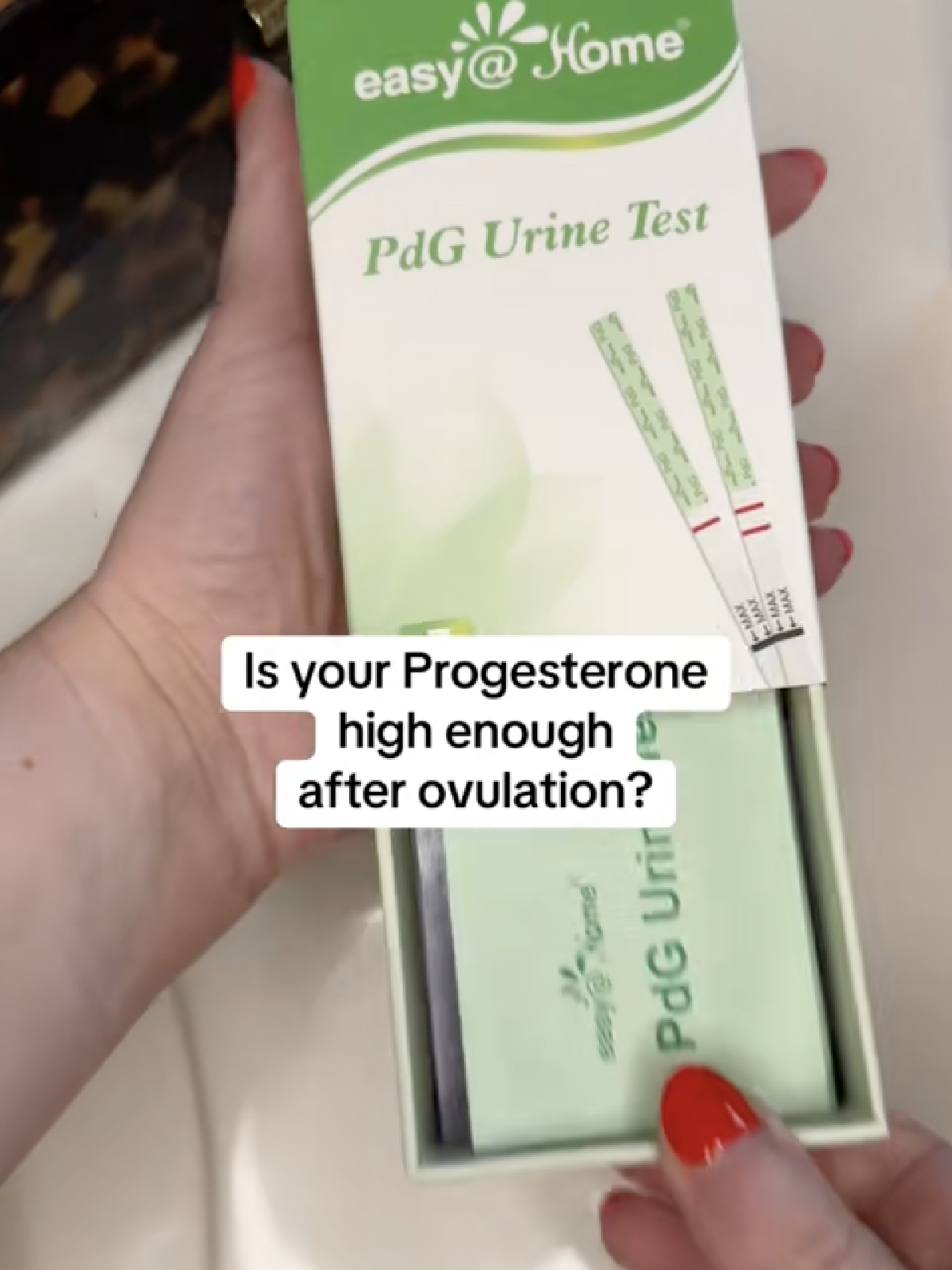 Hand holding an easy@Home PdG progesterone test with the caption "Is your Progesterone high enough after ovulation?"